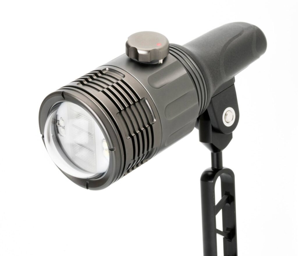 Close-up of an underwater lighting device, showcasing a durable, cylindrical strobe light with adjustable mounting, designed for underwater photography.