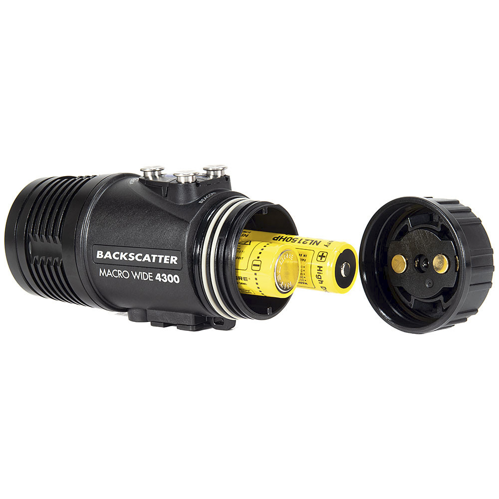Backscatter Macro Wide 4300 Underwater Video Light with battery compartment open, showing a yellow rechargeable battery partially inserted. The design allows for easy battery replacement, emphasizing the light's user-friendly and durable construction for underwater photography.