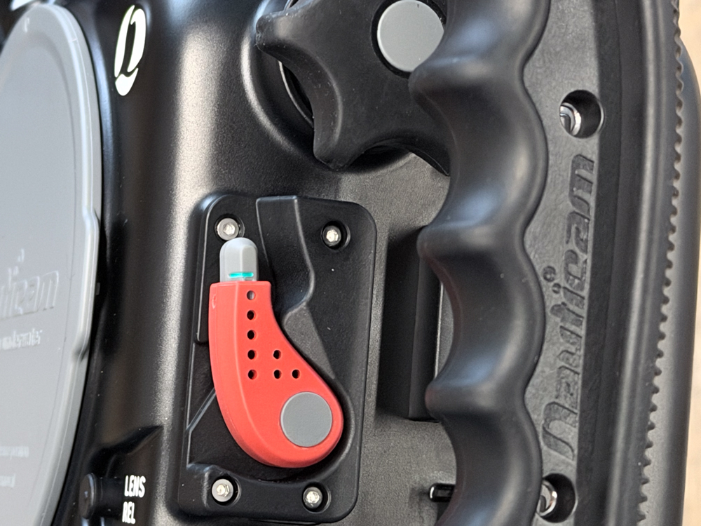 Close-up of the red port-lock lever and N100 port mount on the Nauticam NA-FX5 housing