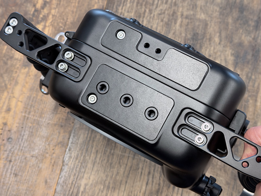 Underside of the Nauticam NA-FX5 housing showing tripod and 1/4-20 mounting points